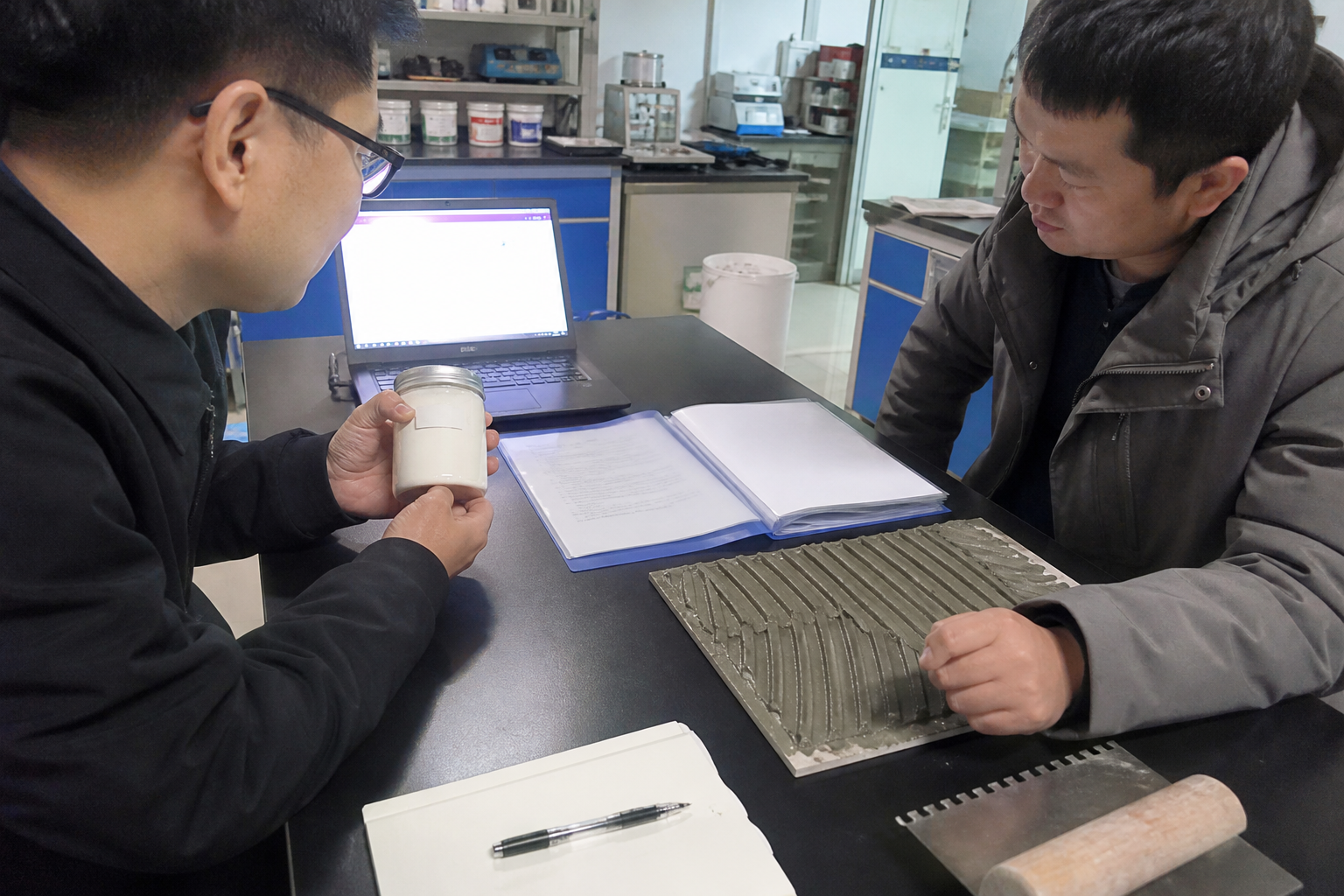 Buyer and technician reviewing HPMC laboratory evidence and tile adhesive application checks