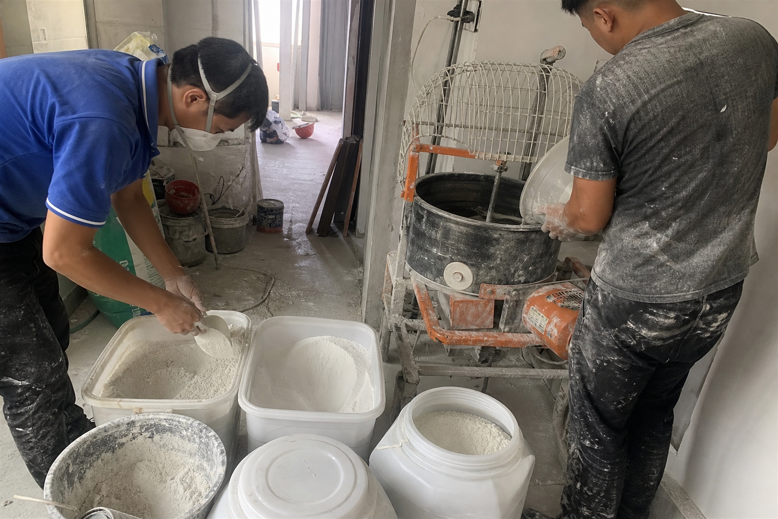 A plant operator weighing wall putty powders and adding measured water in a production trial